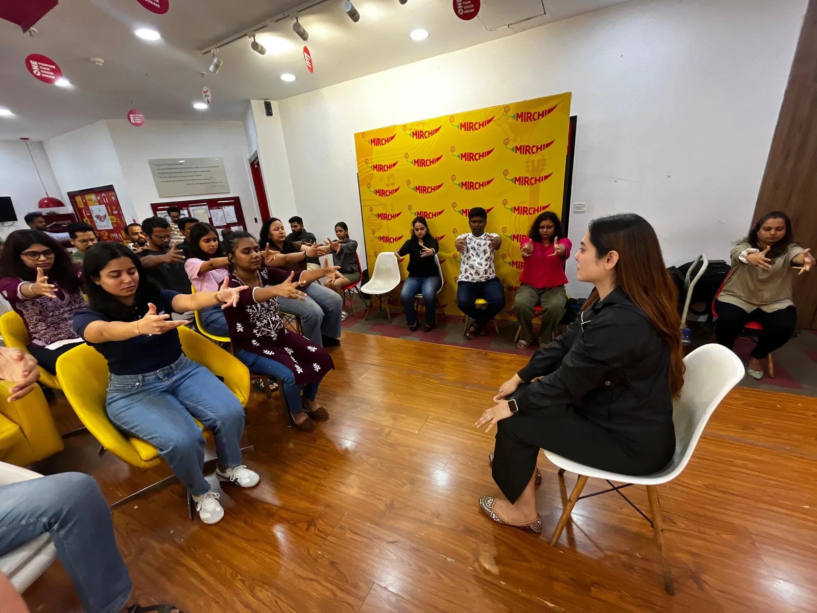 Participants seated together listening during a wellbeing awareness session