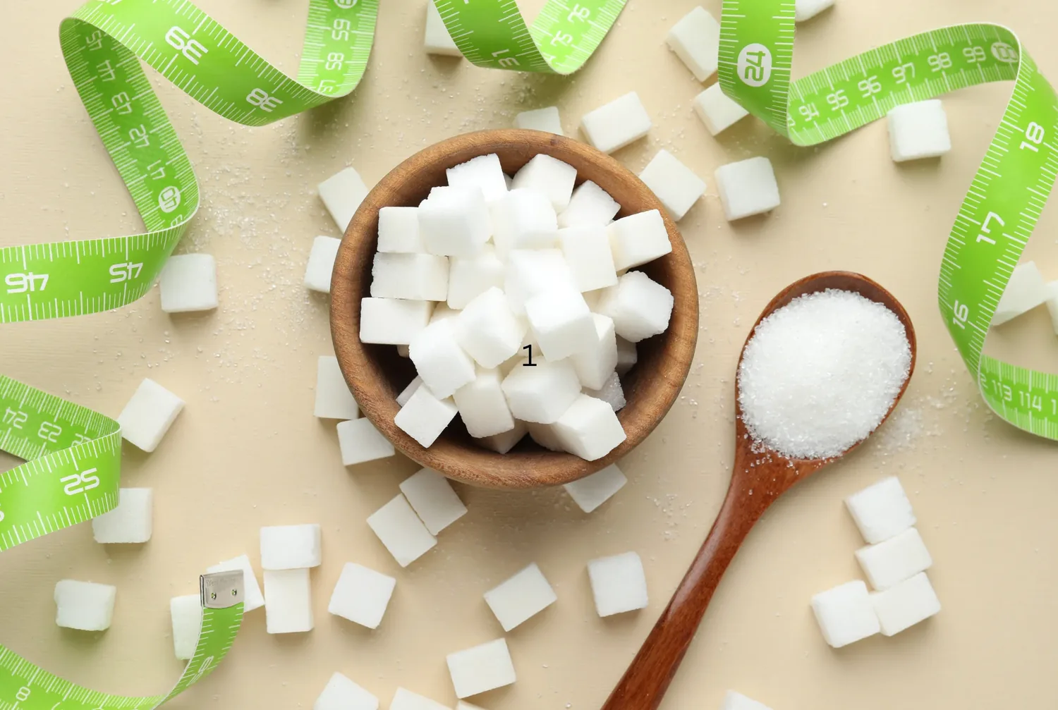 Sugar cubes in a wooden bowl beside a measuring tape, representing everyday awareness of sugar and lifestyle